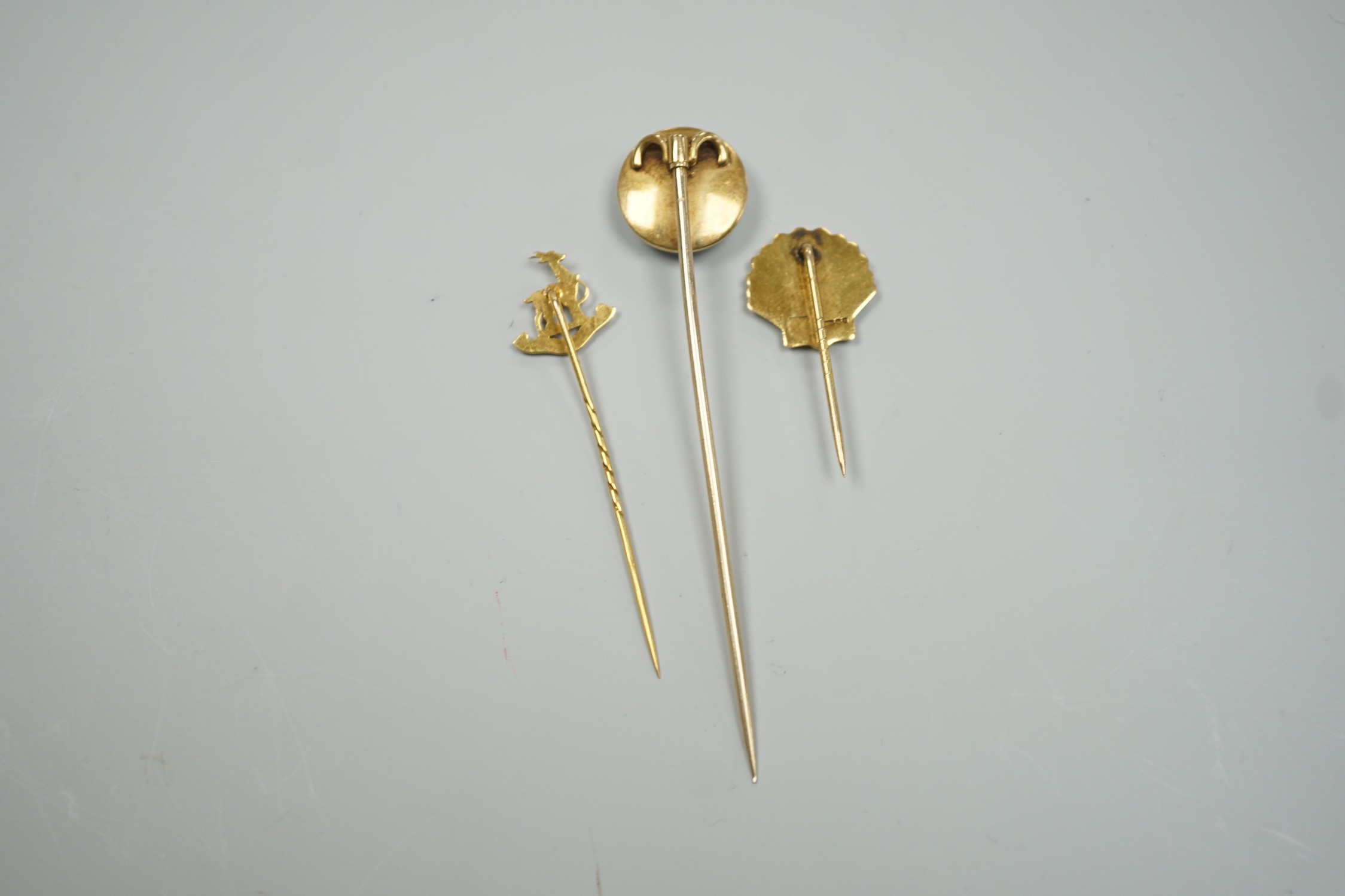 A Victorian yellow metal and banded agate set stick pin, 84mm, a yellow metal Royal Warwickshire Regt. stick pin and a 1970's 9ct gold BP stick pin, gross weight 11.5 grams.